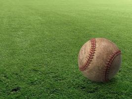 Baseball on the clear green grass turf close-up as macro shot with copy space on the left and top photo