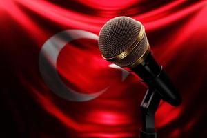 Microphone on the background of the National Flag of Turkey, realistic 3d illustration. music award, karaoke, radio and recording studio sound equipment photo