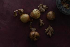 Onions and ginger in a mortar still life food photo