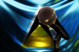 Microphone on the background of the National Flag of Saint Lucia, realistic 3d illustration. music award, karaoke, radio and recording studio sound equipment photo