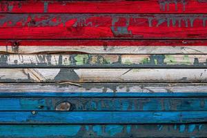 The national flag of Luxembourg  is painted on uneven boards. Country symbol. photo