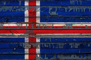 The national flag of Iceland  is painted on uneven boards. Country symbol. photo