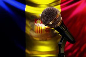 Microphone on the background of the National Flag of Andorra, realistic 3d illustration. music award, karaoke, radio and recording studio sound equipment photo