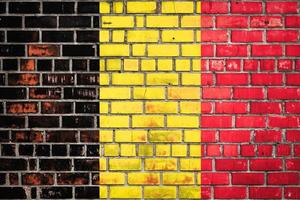 Belgian flag  on a grunge brick background. photo