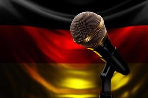 Microphone on the background of the National Flag of Germany, realistic 3d illustration. music award, karaoke, radio and recording studio sound equipment photo