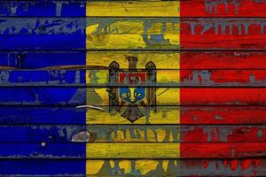 The national flag of Moldova  is painted on uneven boards. Country symbol. photo