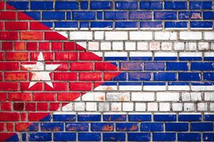 Cuban flag  on a grunge brick background. photo