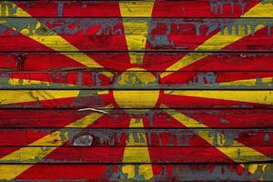 The national flag of Macedonia is painted on uneven boards. Country symbol. photo
