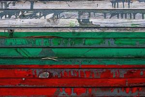 The national flag of Bulgaria is painted on uneven boards. Country symbol. photo