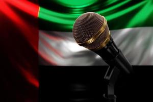 micrófono en el fondo de la bandera nacional de los emiratos árabes unidos, ilustración 3d realista. premio de música, karaoke, radio y equipo de sonido de estudio de grabación foto