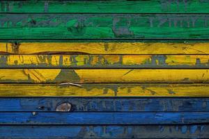 The national flag of Gabon is painted on uneven boards. Country symbol. photo