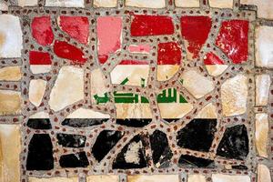 National flag of  Irak on stone  wall background. Flag  banner on  stone texture background. photo