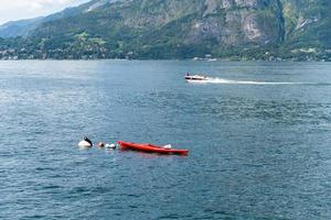 Kayak and speedboat at lake Como photo