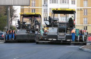 Ukraine, Kharkiv, October 27, 2020. Close-up view on the workers and the asphalting machines. Roller and workers on asphalting and repair of city streets. High quality photo