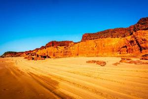 Moon rising over red cliffs photo