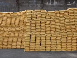 Chemical fertilizer The product stock is packed in sacks yellow , stacked in the warehouse, waiting for delivery. photo