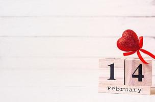 Valentine day. Wooden calendar with February 14 on it. photo