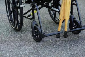 The crutches lean against the wheelchair in open spaces or outdoor. Healthcare and medical concept. photo