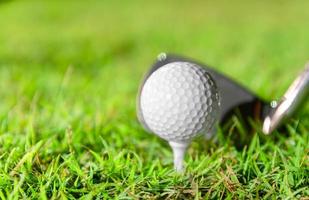 pelota de golf en tee en hierba hermosa en campo de golf para tiro al hoyo en competencia con hierro 7 foto