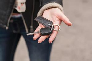 Young girl holding car keys in her hand photo