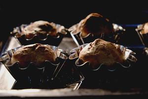 Delicious fluffy muffins in the hot oven photo