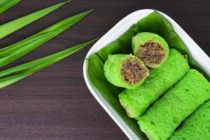 Malaysia sweet dessert with coconut known as kuih ketayap photo