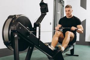 Man running rowing excercise in the gym photo