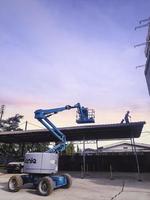 Jakarta, Indonesia, May 24th 2022. Manlift equipment tool supporting the worker fixing the roof. photo