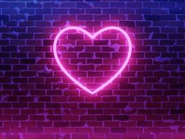 Neon heart. Bright night neon on brick wall photo