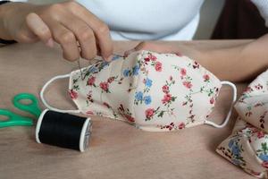 Making DIY masks at home sewing fabric mask handmade cotton protective equipment. photo