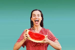 Cheerful woman holding a piece of sliced watermelon. Summer concept photo