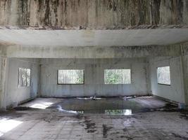 abandoned building Abandoned room with cracked walls and peeling paint There is water inside the horror. photo