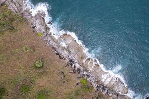 Aerial view Top down seashore wave crashing on seashore Beautiful turquoise sea surface in sunny day Good weather day summer background Amazing seascape top view photo