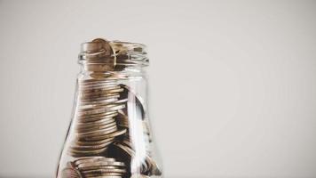 Coins in glass jar for money saving photo