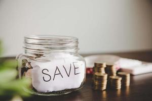 Coins in glass jar for money saving photo