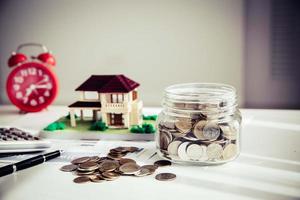 Money saving for house in the glass bottle photo