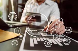 Businessman working with smart phone and laptop and digital tablet computer in  office with digital marketing media  in virtual icon photo