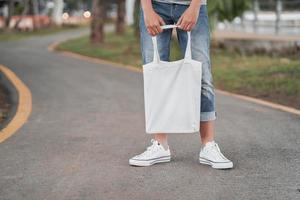 hipster woman with white cotton bag on road photo