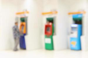 abstract blur man using atm machines for cash withdrawal defocused background photo