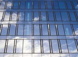 Modern office building facades with glass and reflecting sunlight in the windows photo