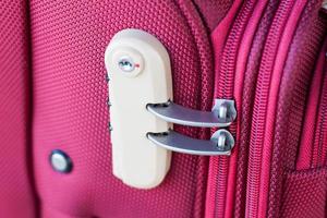 combination lock on red suitcase travel bag photo