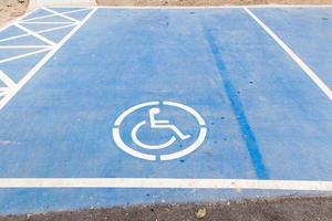 disable sign on blue paint color car park photo