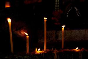 Golden candle light in worship on Buddhist holy day photo