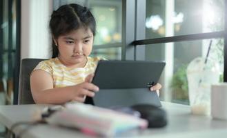 Asian girls are studying in tutoring, studying online at home, girls are bored and tired from tutoring. photo