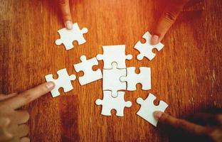 teamwork unity and cooperation concept hand holding jigsaw close-up piece of hand that connect puzzle connected to each other business solution Success Concepts and Strategies photo