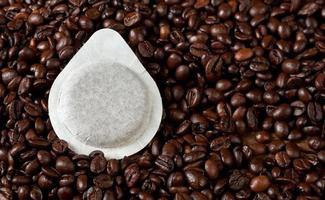 Coffee pods on coffee beans photo