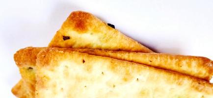 Sugarless and vegetable healthy cracker biscuit slices on the gray white studio background. Food background design. Suitable for promotion of food and beverage industry and company, food advertising. photo