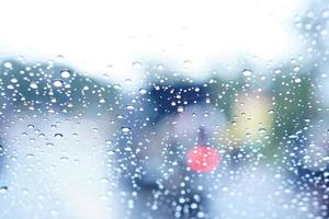 Blurred background of raindrops on the car windshield photo