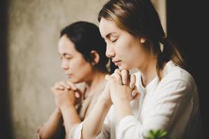 Two women praying worship believe photo