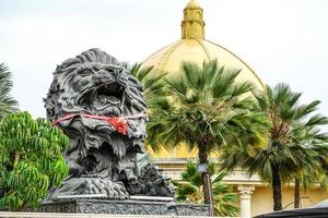 big black lion statue front of building. photo